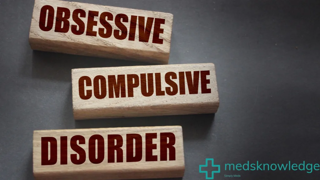 "Wooden blocks spelling out the words 'OBSESSIVE COMPULSIVE DISORDER' on a dark background with the logo 'medsknowledge' and a green medical cross symbol."