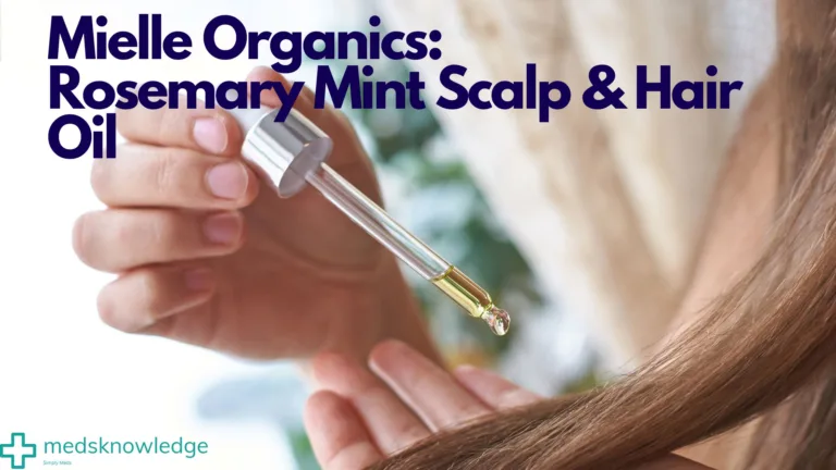 Dropper applicator dispensing Mielle Organics Rosemary Mint Scalp & Hair Oil onto a woman's hair strands.